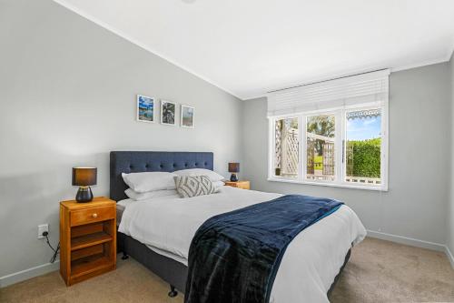 a bedroom with a large bed and a window at Central Heritage Villa in Rotorua