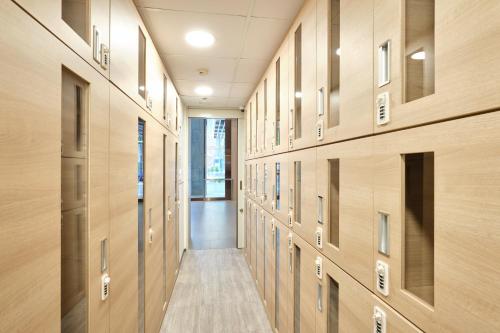 a hallway with wood paneled walls and a long corridor at Sotetsu Grand Fresa Saigon in Ho Chi Minh City
