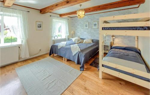 a bedroom with two beds and a bunk bed at 2 Bedroom Cozy Home In Munka-Ljungby in Munka-Ljungby