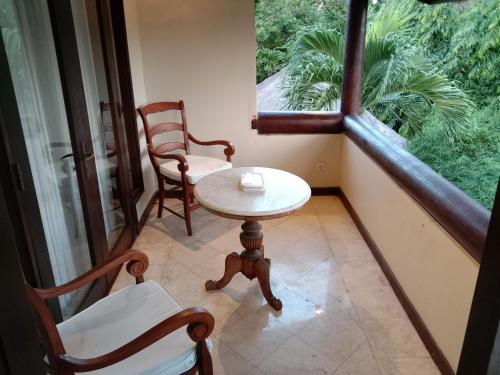 a room with two chairs and a table and a window at KUTA - 4BR Villa with Private XL Pool in Kuta