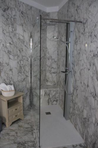 a shower with a glass door in a bathroom at Il Giardino della Scuncerta in Lecce