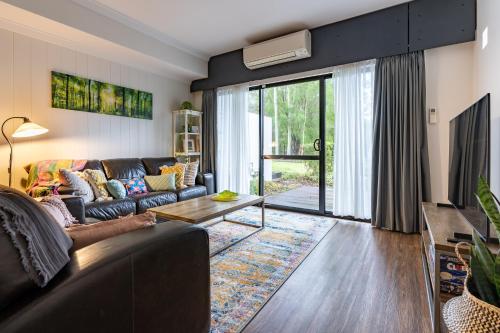 a living room with a couch and a tv at At Forest Stay in Margaret River Town