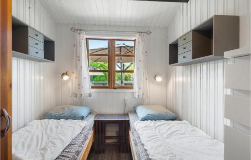 2 camas en una habitación pequeña con ventana en Beautiful Home In Slagelse With Kitchen, en Slagelse
