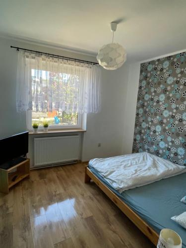 Кровать или кровати в номере Apartament wakacyjny Chałupy