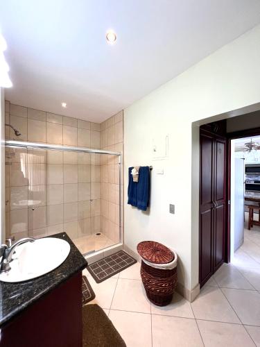 a bathroom with a sink and a shower at Oceanview Rancho with Two bedroom & Two baths in Coco