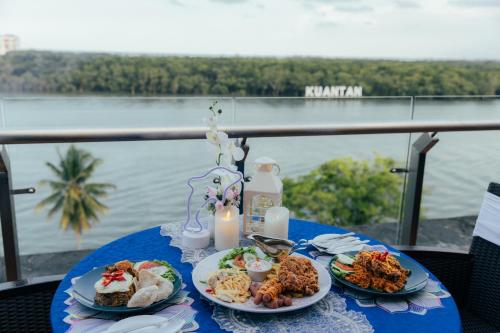 a blue table with two plates of food on it at Hotel Sentral Kuantan @ Riverview City Centre in Kuantan