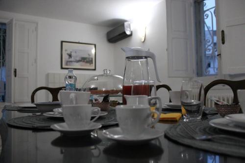 a table with plates and cups and a blender on it at Il Giardino della Scuncerta in Lecce