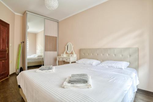 a bedroom with a large white bed with towels on it at Guest House Jovana in Kotor