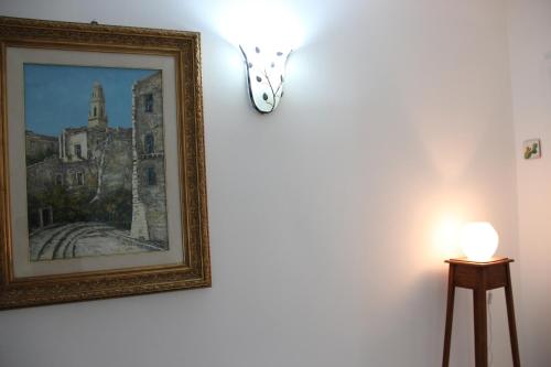a picture hanging on a wall with a butterfly on it at Il Giardino della Scuncerta in Lecce