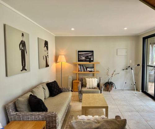 a living room with a couch and a table at Rosella - Bushland Hideaway in Yallingup