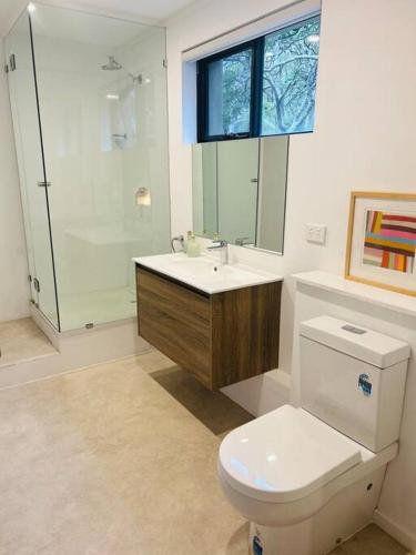 a bathroom with a toilet and a sink and a shower at Rosella - Bushland Hideaway in Yallingup