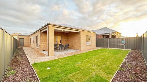 a house with a lawn in front of it at The Grove Home by GoodLive in Tarneit
