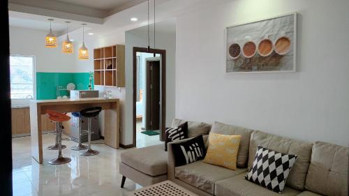 a living room with a couch and a kitchen at An's Oceanus in Nha Trang