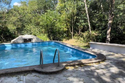 a swimming pool in the middle of a yard at 1 bedroom home with pool/patio in a Mayan village. in Cuncunul