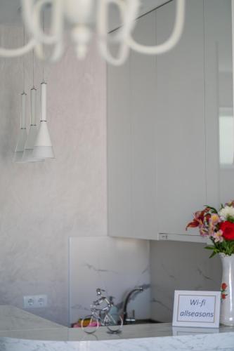 a kitchen with a sink and a vase of flowers at All Seasons in Telavi