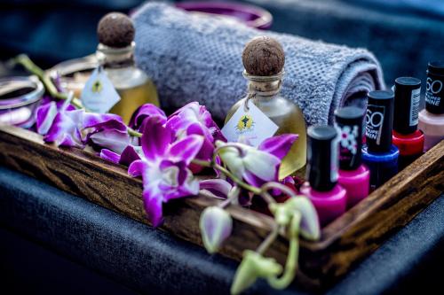 a wooden box with bottles of cosmetics and flowers at Hotel Sarowar Pokhara-Luxury Hospitality in the Heart of Pokhara in Pokhara