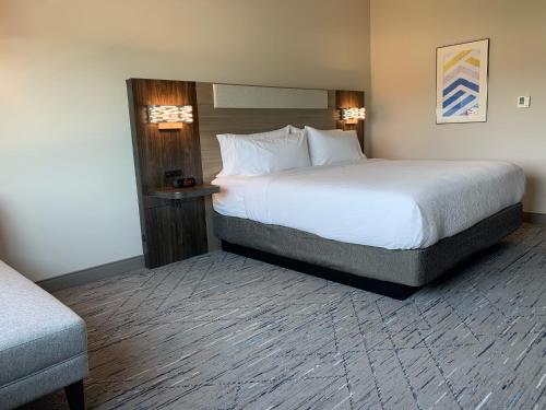 a hotel room with a large bed and a chair at Holiday Inn Express & Suites - Courtenay - Comox by IHG in Courtenay