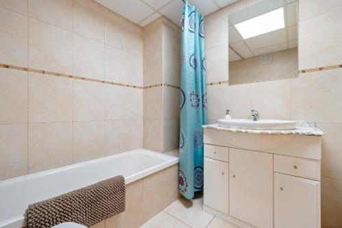 een badkamer met een bad en een wastafel bij Sara in L'Aldea