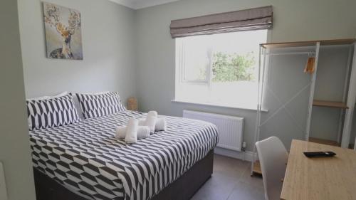 a bedroom with a bed with white candles on it at Coastal View House in Buncrana
