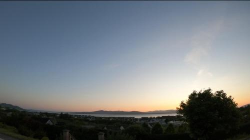 a view of the sunset from the top of a hill at Coastal View House in Buncrana