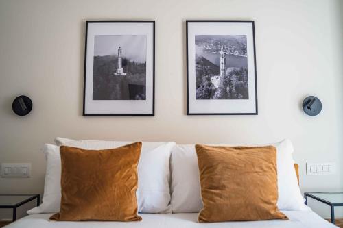 a white couch with three pictures on the wall at Gaby Lake Suites in Como