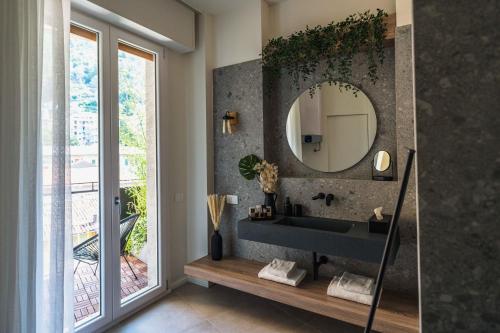 a bathroom with a sink and a mirror at Gaby Lake Suites in Como