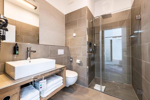 a bathroom with a sink and a shower at Premier Inn Wuppertal City Centre in Wuppertal