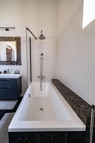 a large white bath tub in a bathroom at Kníže Ferdinand Apartments in Mikulov