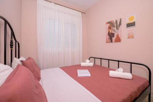 a bedroom with a bed with two towels on it at Zoe's City Apartment in Alexandroupoli