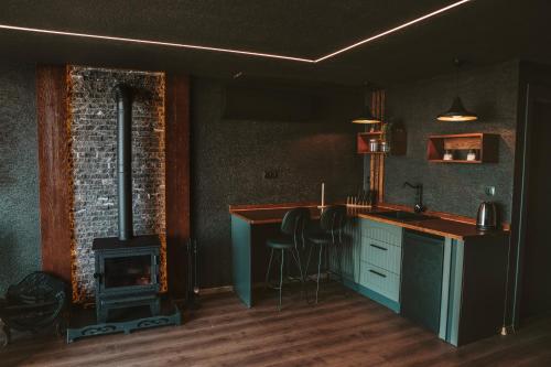 a kitchen with a fireplace and a stove at Woodlife Bungalov in Ardeşen