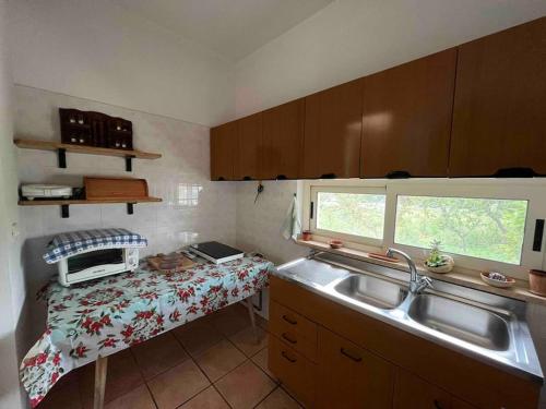 a small kitchen with a sink and a window at Fusella Country House/Villa a Polignano Vista Mare in Polignano a Mare