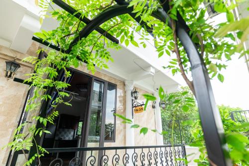 a balcony with a black railing and trees at IRIS HILL VILLA in Thôn Dương Xuân Hạ