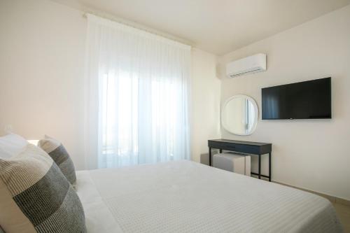 Ένα ή περισσότερα κρεβάτια σε δωμάτιο στο Villa Ariadne