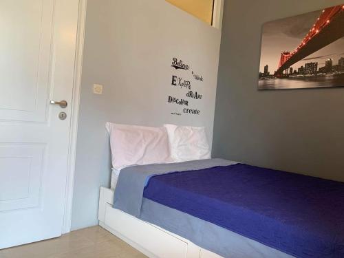 a bedroom with a bed and a picture on the wall at Corfu town Kanoni apartment in Corfu