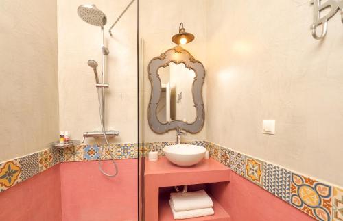a bathroom with a sink and a mirror at The Yiameli Collection - Levandi in Skinária