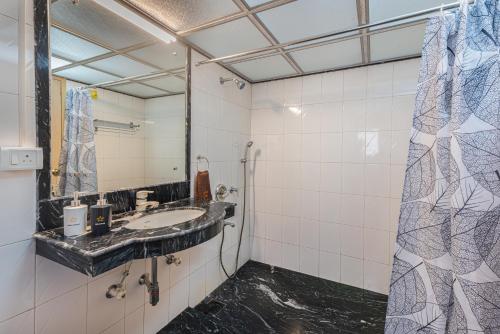 a bathroom with a sink and a mirror at SaffronStays Grandiosa - 4 BDR pet-friendly, pool villa Khandala in Khandala