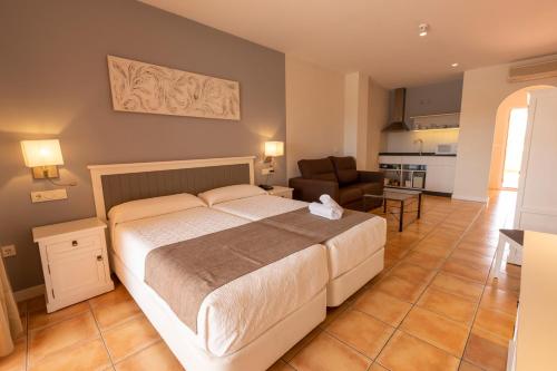 a bedroom with a bed and a living room at Dunas de Doñana Resort in Matalascañas
