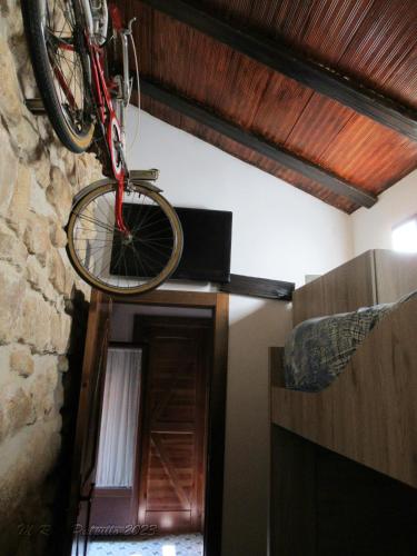 a bicycle hanging from the ceiling of a room at La alegria de las cuevas in Rus