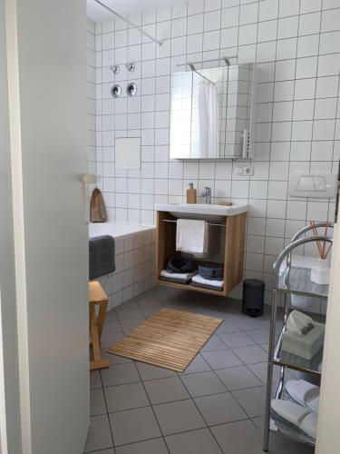 a bathroom with a tub and a sink and a mirror at Ferienwohnung auf ehemaligem Mühlengrund in Neuhaus am Inn