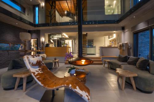 a living room with a couch and a table at #SKGH Arbitrage Hyperluxe Villa -near Pozar Baths & Kaimaktsalan mountain in Sarakinoí