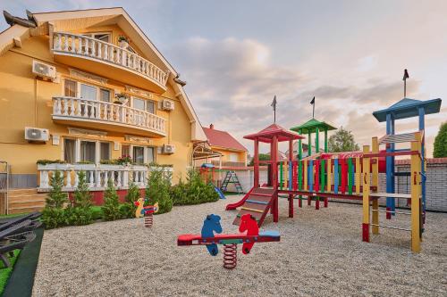 a playground in front of a building at Tokajer Wellness Panzió in Keszthely