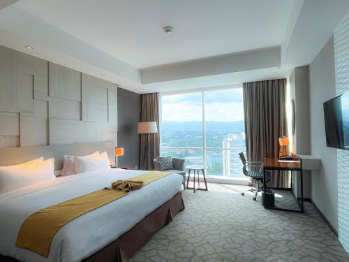 a hotel room with a large bed and a large window at Crowne Plaza Bandung by IHG in Bandung