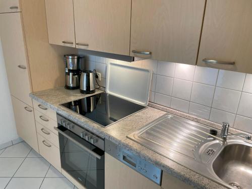 a kitchen with a sink and a counter top at Apartment Lina mit Balkon in Zempin