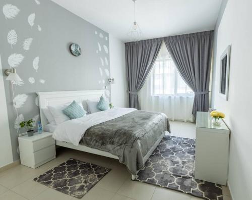 a bedroom with a large bed and a window at Supurb 2 Bed Apt Beach Front (City View) in Abu Dhabi