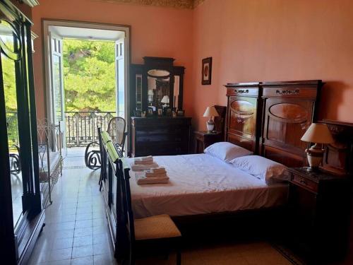 ein Schlafzimmer mit großem Bett und Fenster in der Unterkunft Villa Giuseppina Miramare in San Menaio