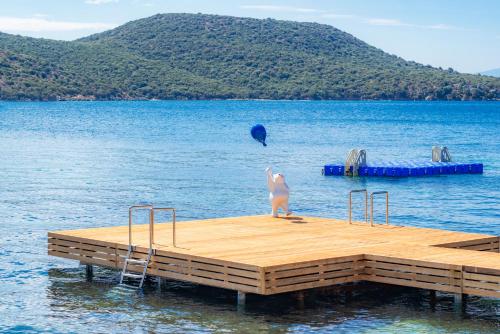 a statue of a cat standing on a dock in the water at Doria Hotel Bodrum-City Center in Bitez