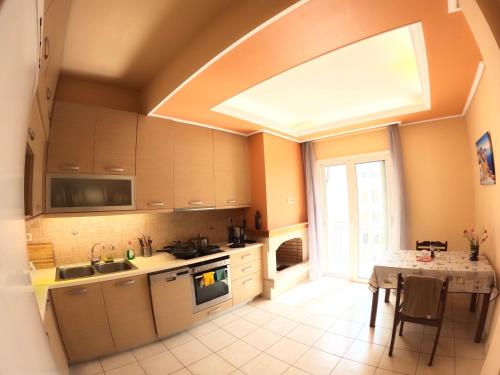 a large kitchen with a table and a window at Big Apt 3bed 3bath 10 min walk Acropolis in Athens