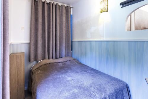a small bedroom with a bed and a window at Cigale 2 in Argelès-sur-Mer