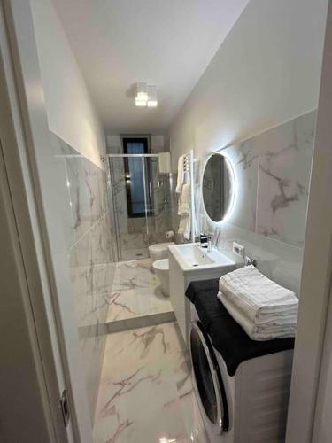 a bathroom with a sink and a toilet and a mirror at Studio Apartment Near Bocconi in Milan