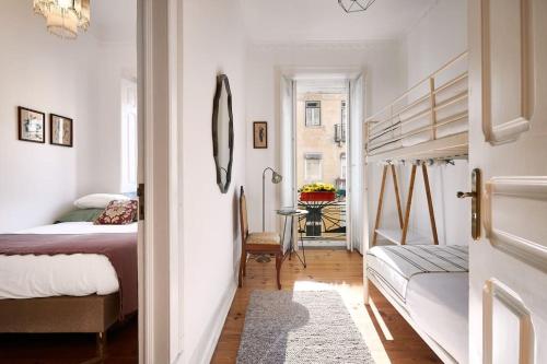 a bedroom with a bed and a table in a room at Charming Lisbon Central Apartment in Lisbon